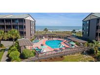 Beautiful community pool area with ocean views and ample lounging space at 202 North Ocean Blvd. # 109, North Myrtle Beach, SC 29582