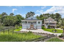 Inviting home with a double-door garage and a charming front porch, perfect for enjoying the outdoors at 214 Olde Harbour Ct, Little River, SC 29566