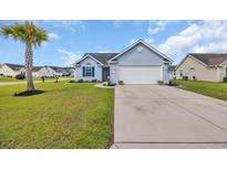 Charming single-story home with a two-car garage and a well-maintained lawn with mature palm tree at 252 Heath Dr., Longs, SC 29568
