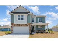 Charming two-story home features a stone facade, attached garage, and inviting front porch at 259 Konik St., Conway, SC 29526