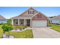 Charming brick home with a two-car garage, a landscaped front yard, and decorative shutters at 3078 Gillham Loop, Myrtle Beach, SC 29588