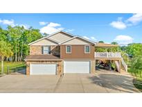Spacious home featuring a multi-car garage, stone accents, and covered boat parking at 3721 Ed Smith Ave., Myrtle Beach, SC 29588