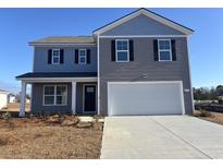 Two story home with a two car garage, black shutters and light gray siding on a sunny day at 374 Acosta Circle, Conway, SC 29527