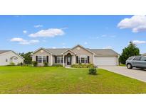 Charming single-story home featuring a well-maintained lawn and attached two-car garage at 520 Winged Elm St., Loris, SC 29569