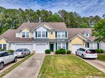 Inviting townhome with manicured lawn, attached garages, and charming curb appeal at 6203 Catalina Dr. # 212, North Myrtle Beach, SC 29582