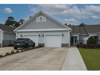 Charming home featuring a two-car garage, gray siding, and well-maintained landscaping at 797 Salerno Circle # C, Myrtle Beach, SC 29579