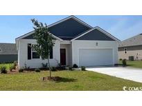 Charming single-story home with a well-manicured lawn and attached two-car garage at 857 Farmers Passage Loop, Loris, SC 29569