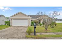Charming single-story home with a well-maintained lawn, two-car garage, and inviting curb appeal at 1220 Dunraven Ct., Conway, SC 29527
