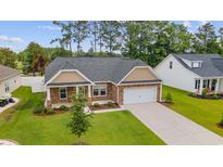 Beautiful single-story home featuring a stone facade, attached two-car garage, and well-manicured lawn at 131 Crabapple Dr., Longs, SC 29568