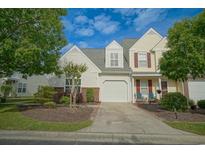 Charming two-story townhome with attached garage and well-maintained landscaping at 153 Wimbledon Way # 153, Murrells Inlet, SC 29576