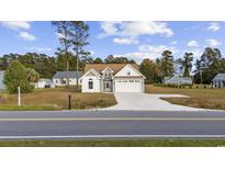 Charming single-Gathering home with a well-maintained lawn and two-car garage at 1727 Cane Branch Rd., Loris, SC 29569