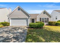 Charming single-story home featuring a two-car garage and well-manicured landscaping at 2336 Windmill Way, Myrtle Beach, SC 29579