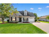 Charming one story home featuring a well-manicured lawn and a brick accent exterior at 2595 Buck Scrape Rd., Myrtle Beach, SC 29588