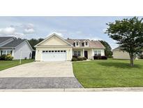 Charming single-story home with a well-manicured lawn, a two-car garage, and attractive landscaping at 348 Basswood Ct., Conway, SC 29526