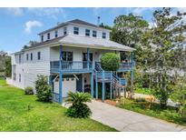 Charming home featuring a metal roof, double decks, and a convenient drive-under garage at 3659 Jordan Landing Rd., Murrells Inlet, SC 29576