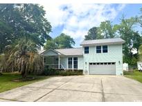 Inviting two-story home with a two-car garage and lovely curb appeal is surrounded by lush landscaping at 3670 Earls Rd., Myrtle Beach, SC 29588
