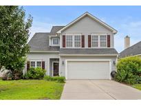 Charming two-story home with gray siding, shutters, landscaped yard, and a two-car garage at 373 Skyland Pines Dr., Myrtle Beach, SC 29588