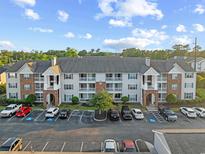 Attractive condo building featuring brick accents, multiple balconies, and ample parking spaces at 3762 Citation Way # 1023, Myrtle Beach, SC 29577