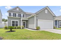 Charming two-story home with gray siding, manicured lawn, and attached two-car garage at 4927 Sandlewood Dr., Myrtle Beach, SC 29579
