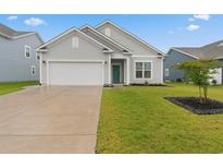 Charming single-story home with a well-manicured lawn and a two-car garage at 5031 Vinesia Dr., Myrtle Beach, SC 29579