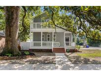 Charming two-story home with a inviting porch, landscaped yard and a large tree providing shade at 505 Beaty St., Conway, SC 29526