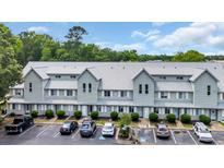 Exterior view of a two-story condo building featuring light blue siding, a gray roof, and well-maintained landscaping at 510 Fairwood Lakes Dr. # 923G, Myrtle Beach, SC 29588