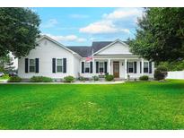 Charming one-story home features a green lawn, American flag, and classic curb appeal at 548 Fox Chase Dr., Conway, SC 29527