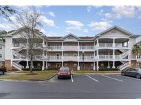 Charming condo building with multiple stories, covered decks, and well-maintained landscaping, near parking at 5750 Oyster Catcher Dr. # 531, North Myrtle Beach, SC 29582