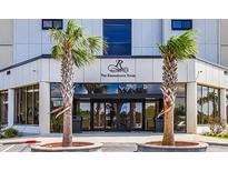 Renaissance Tower building entrance featuring palm trees and glass doors reflecting the beautiful surroundings at 5905 S Kings Hwy. # 1816 Rt, Myrtle Beach, SC 29575
