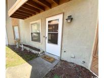 Inviting condo front entrance with decorative storm door, stone landscaping, and unit number at 600 65Th Ave. N # 8, Myrtle Beach, SC 29572