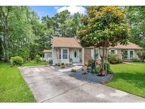 Charming single-story home featuring a well-manicured lawn, mature tree, and inviting front entrance at 103 Robin Ct., Murrells Inlet, SC 29576