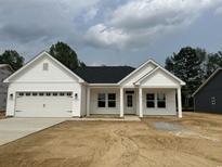 Charming single-story home with white siding, a two-car garage, and a covered front porch at 126 Westfield Circle, Conway, SC 29526