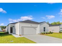Charming single-story home featuring a two-car garage, and manicured lawn at 144 Warner Crossing Way, Loris, SC 29569