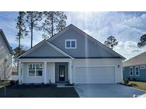 Charming single-story home featuring a two-car garage, well-manicured lawn, and classic architectural details at 161 Stride Ct., Myrtle Beach, SC 29588