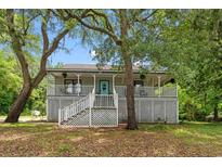 Charming home featuring a spacious front porch and beautiful landscaping in a tranquil setting at 1936 Lees Landing Circle, Conway, SC 29526