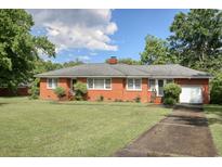 Charming brick home with a well-maintained lawn, mature trees, and an attached one-car garage at 2004 Seitter St., Georgetown, SC 29440