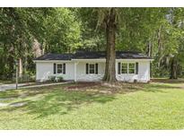 Charming single-story home with white siding, black shutters, and a well-maintained front lawn at 203 Deer Trace, Myrtle Beach, SC 29588