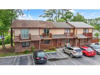 Charming townhome complex featuring brick and siding exteriors, small balconies, and well-maintained parking areas at 218 Waccamaw Village Dr. # 218, Myrtle Beach, SC 29579