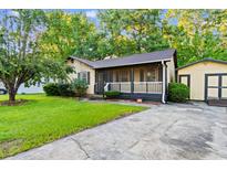 Charming single-story home with a screened porch and driveway offers great curb appeal at 238 Stonebrook Dr., Myrtle Beach, SC 29588