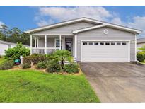 Charming home featuring a lovely front porch, well-maintained landscaping, and a two-car garage at 263 Walden Lake Rd., Conway, SC 29526