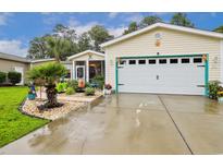 Charming home featuring a one-car garage, vibrant landscaping and an inviting screened-in porch at 356 Lakeside Crossing Dr., Conway, SC 29526