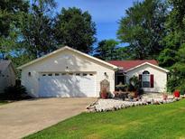 Charming single-story home boasts a two-car garage and beautifully landscaped front yard with decorative rock and shrubbery at 3904 Williamson Circle, Myrtle Beach, SC 29579