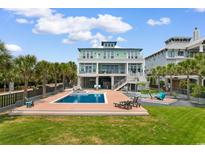 Stunning backyard with a private pool, lounge chairs, and a spacious deck perfect for outdoor entertaining at 4900 N Ocean Blvd., Myrtle Beach, SC 29577