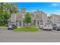 Charming townhome with gray siding, red shutters, manicured landscaping, and convenient parking at 503 20Th Ave. N # 15B, North Myrtle Beach, SC 29582
