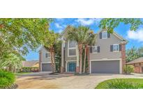Stucco home featuring a dual car garage, brick accents, professional landscaping, and a covered entry with double doors at 510 Rum Gully Rd., Murrells Inlet, SC 29576