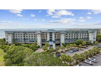Beautiful multi-story condo building offers stunning ocean views with lush landscaping and ample parking at 601 Retreat Beach Circle # 213, Pawleys Island, SC 29585