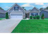 Charming home featuring a two-car garage, manicured lawn, and inviting curb appeal at 617 Chiswick Dr., Conway, SC 29526