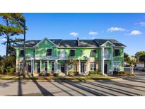 Charming townhouses with a vibrant green exterior, black shutters and manicured landscaping at 788 Gabreski Ln. # B4, Myrtle Beach, SC 29577