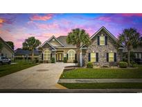 Charming home featuring a well-manicured lawn, a double-wide driveway and mature palm trees at 837 Sand Binder Dr., Myrtle Beach, SC 29579