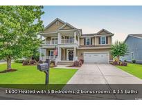 Charming two-story home with a inviting front porch, a well-manicured lawn and a two car garage at 1227 Cypress Shadow Ct., Murrells Inlet, SC 29576